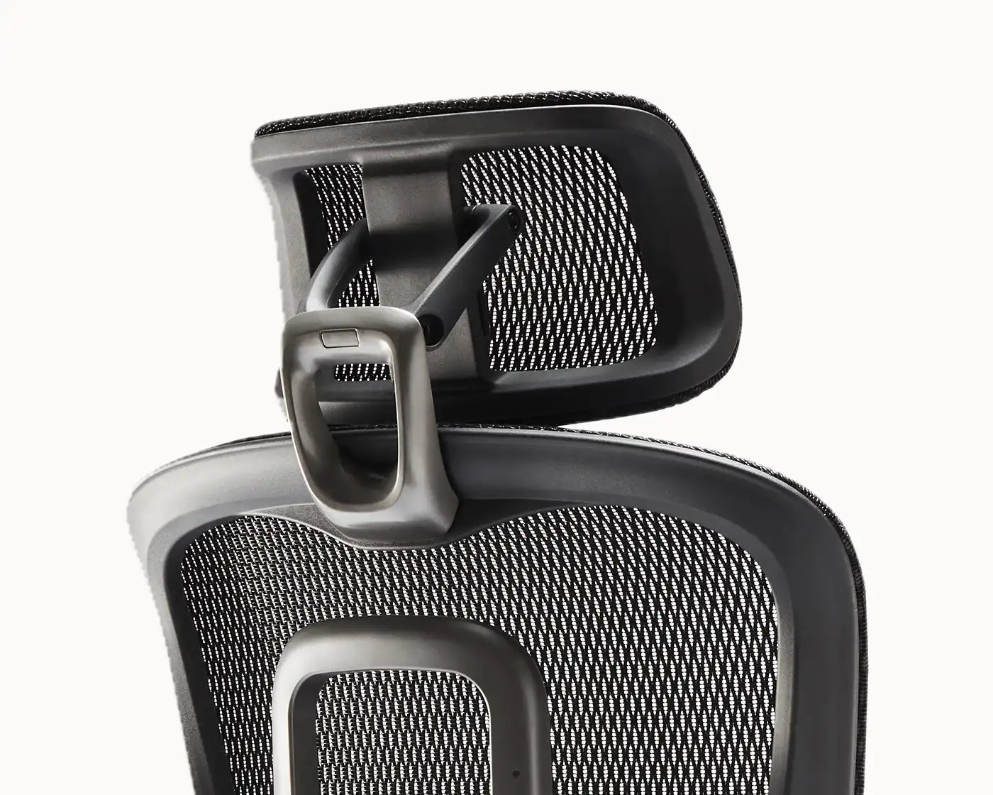 Close-up of the adjustable headrest of the Flujo Elli Ergonomic Chair, showcasing its mesh design and ergonomic support.