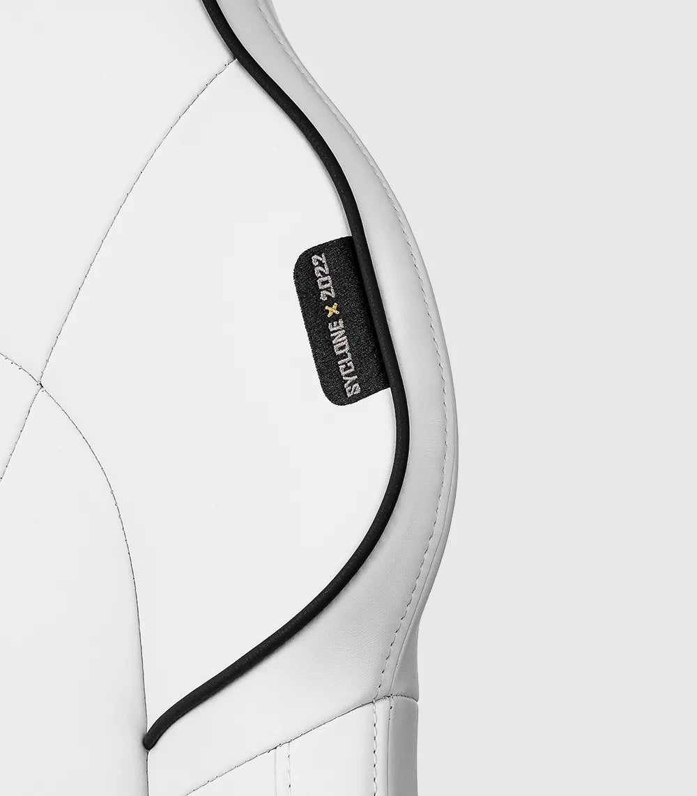 Detail of the white SYCLONE PRO gaming chair's side stitching and label.
