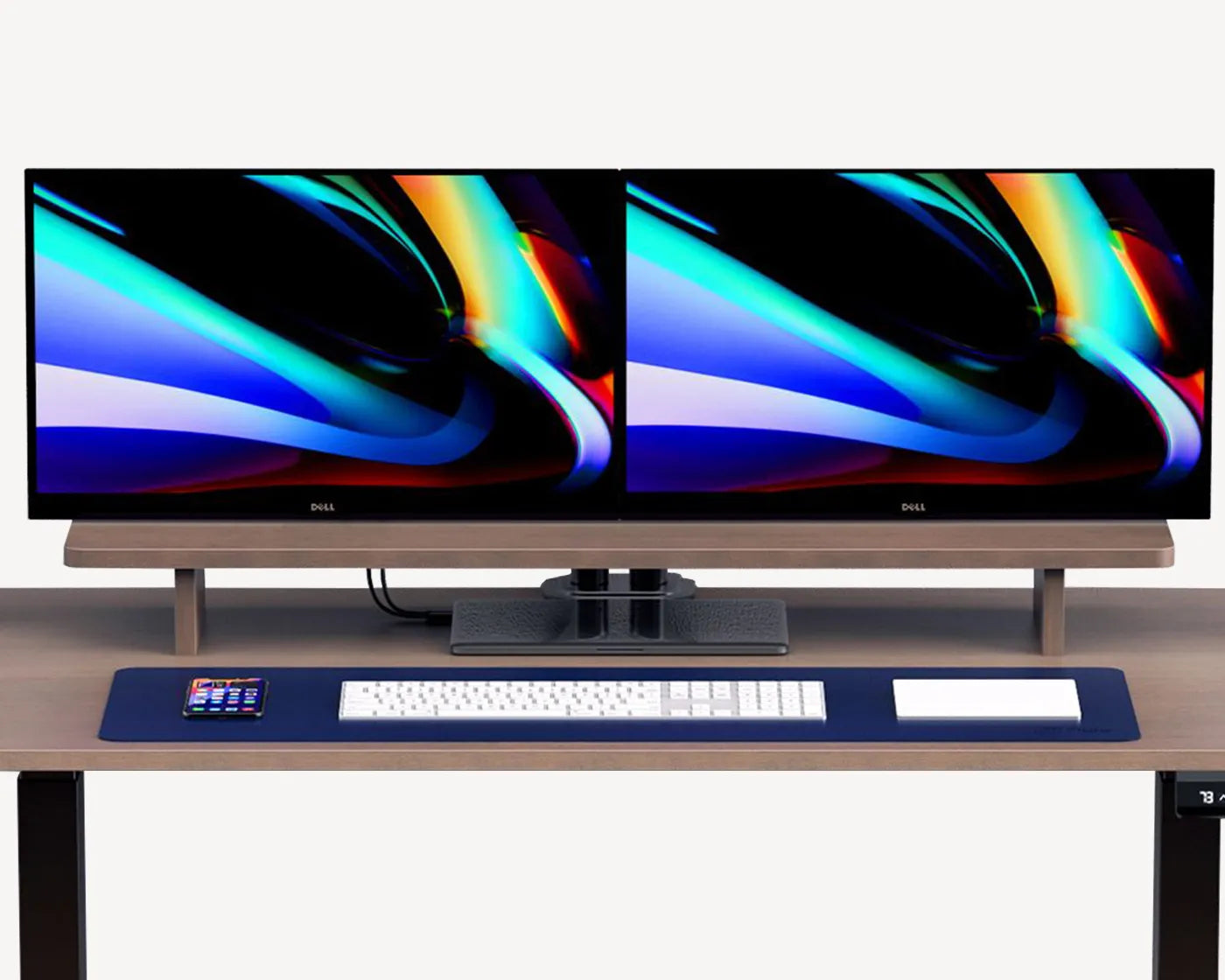 Robust ergonomic monitor riser made from high-quality molded plywood, capable of holding up to 10kgs, displayed with two monitors on top.