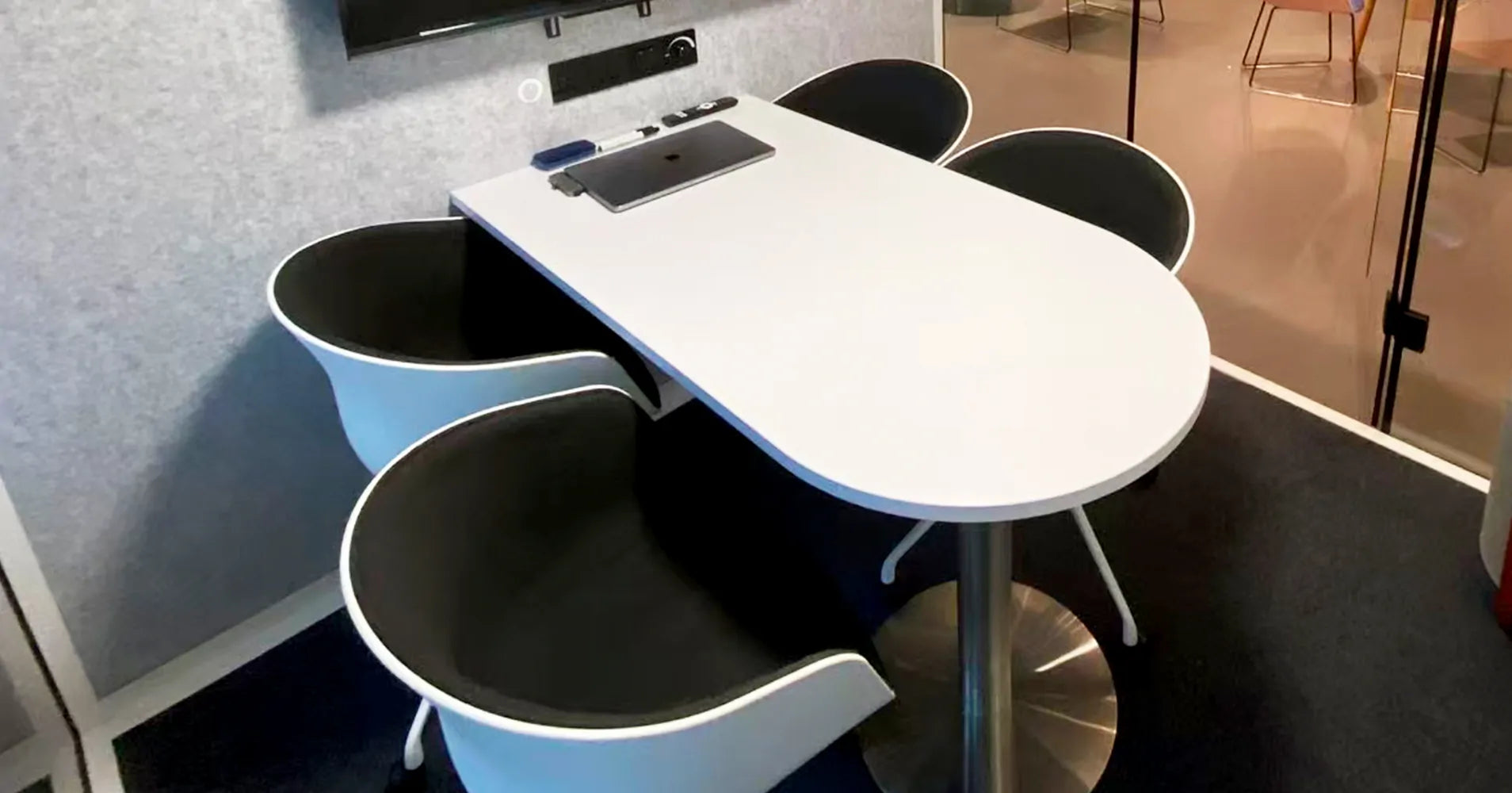 Flujo acoustic office meeting pod interior with white oval table and four chairs for 4 person discussions in Singapore