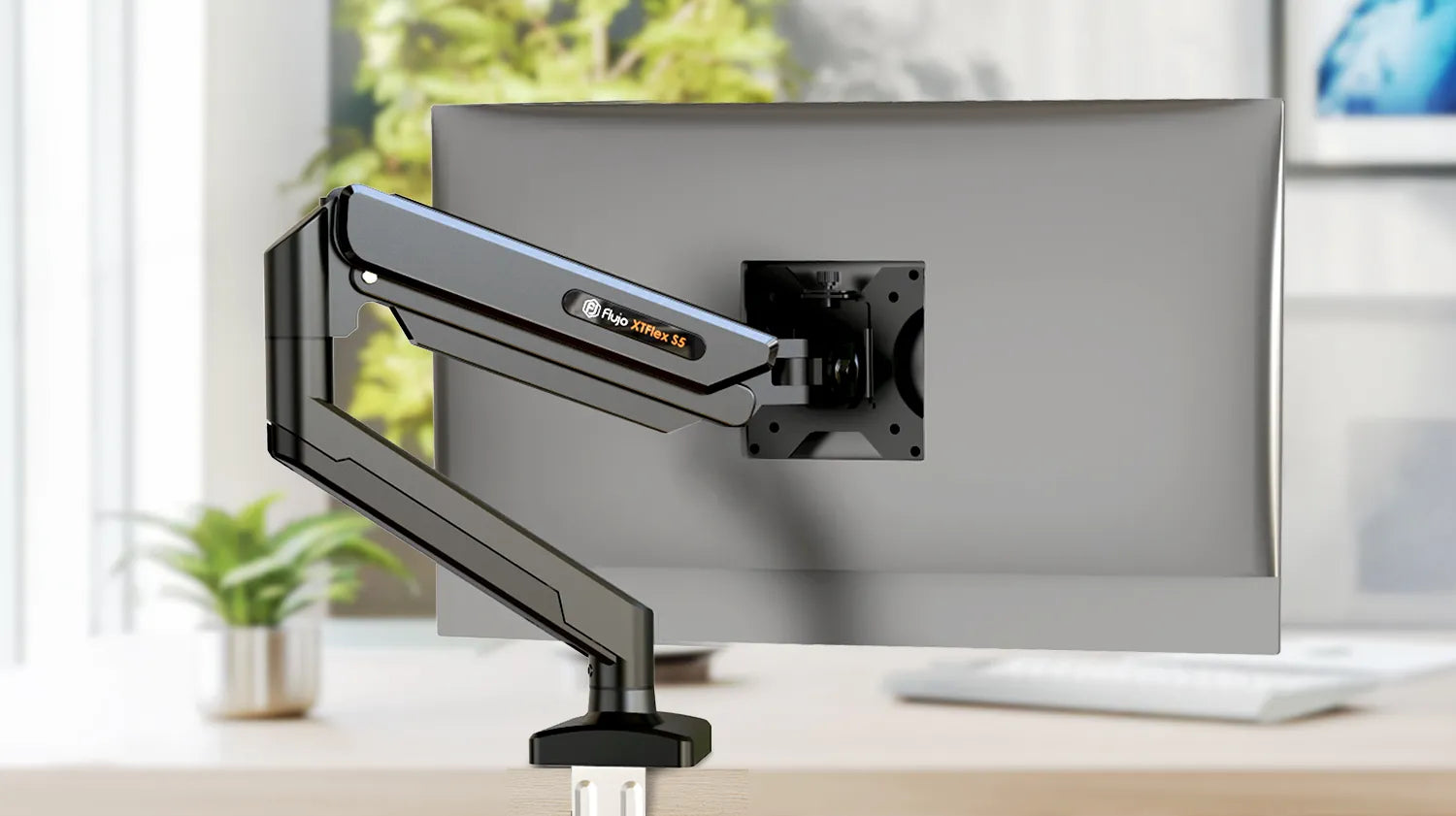 Flujo XTriFlex S5 monitor arm mounted on desk with clear workspace view.