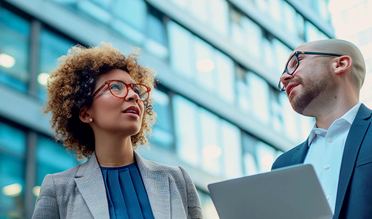 Professional woman using a standing desk in a vibrant office environment