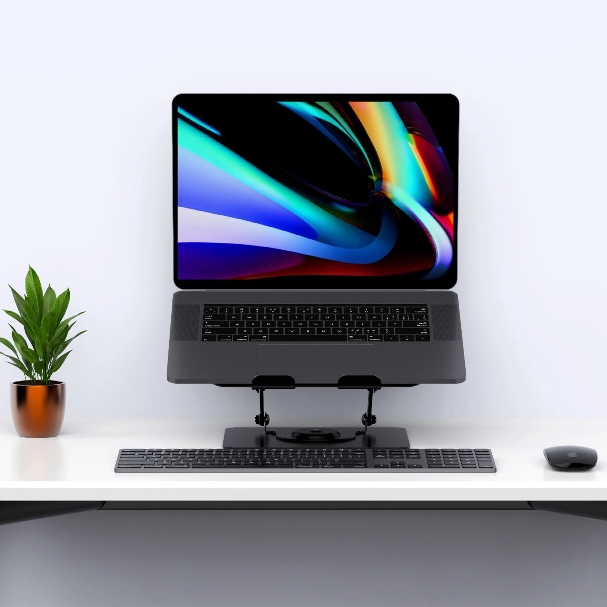 Sleek black adjustable laptop stand enhancing ergonomic desk setup with a plant accent in Singapore.