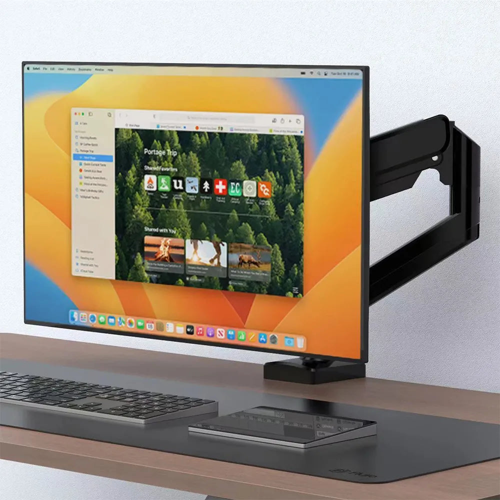 Ergonomic workspace setup with a monitor arm supporting a sleek monitor, enhancing desk ergonomics in Singapore.