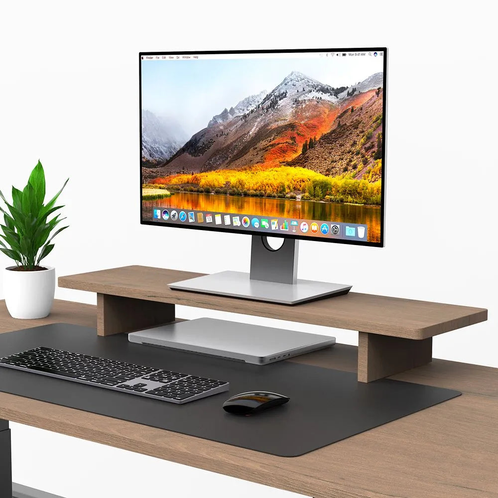 Sleek monitor riser holding a monitor above a stylish desk setup, enhancing workspace ergonomics in Singapore.