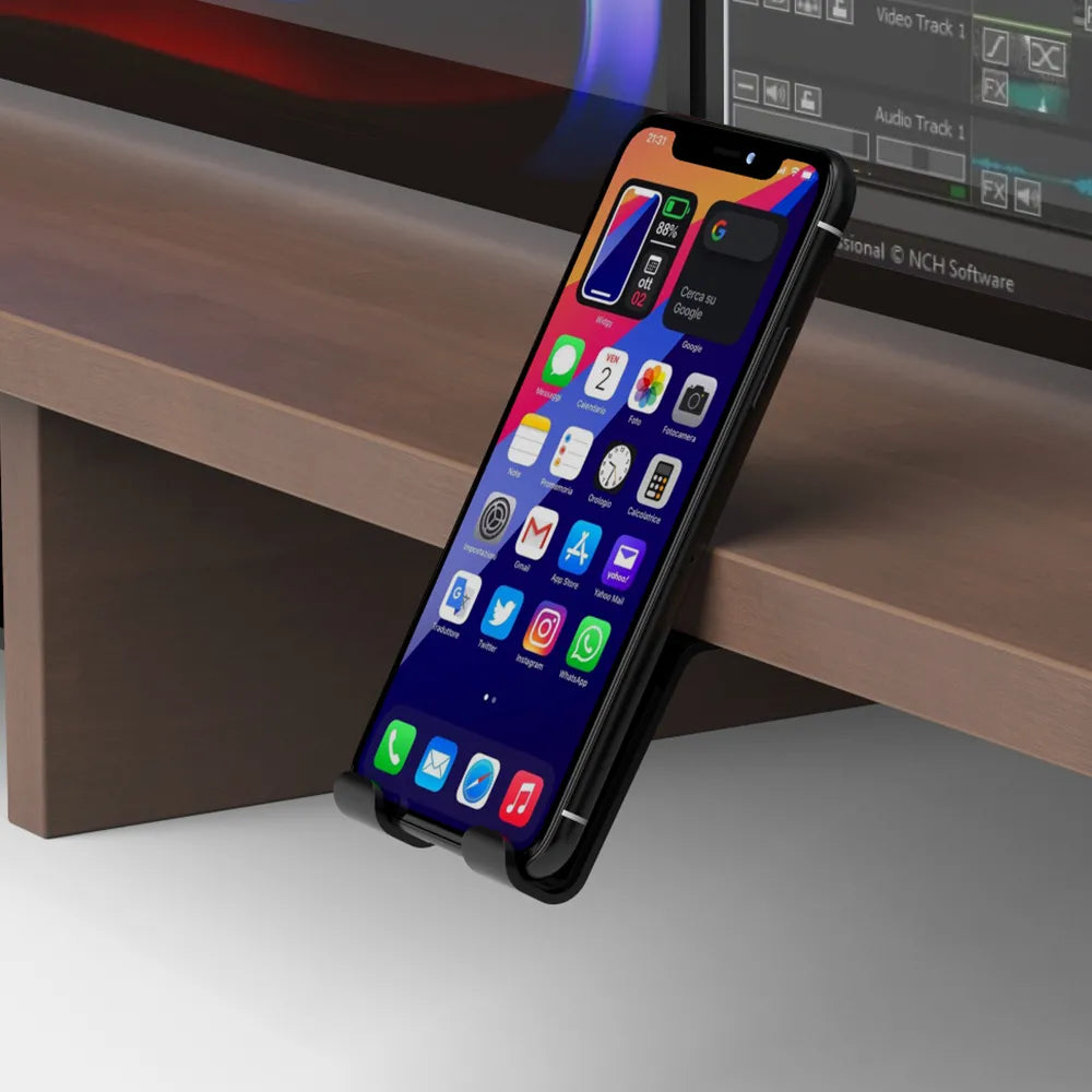 Smartphone resting on a monitor riser's integrated phone stand, part of an organized desk setup in Singapore.