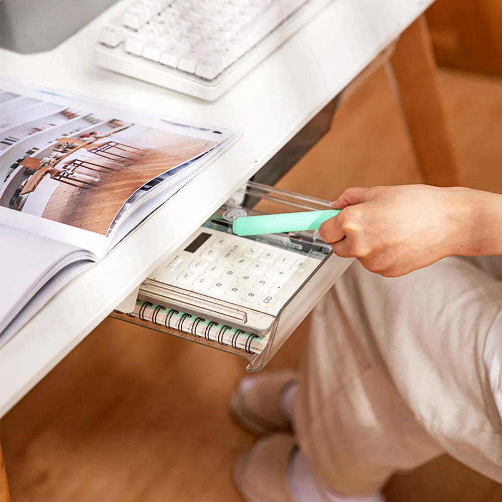 Person using a clear pull-out drawer attached to a white shelf, demonstrating the drawer's convenience for storing and retrieving items.