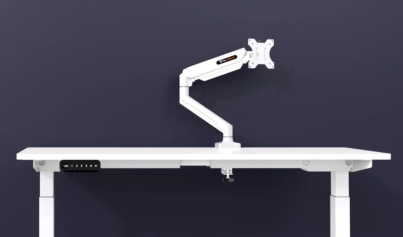 Flujo white monitor arm attached to a minimalist desk with digital height display