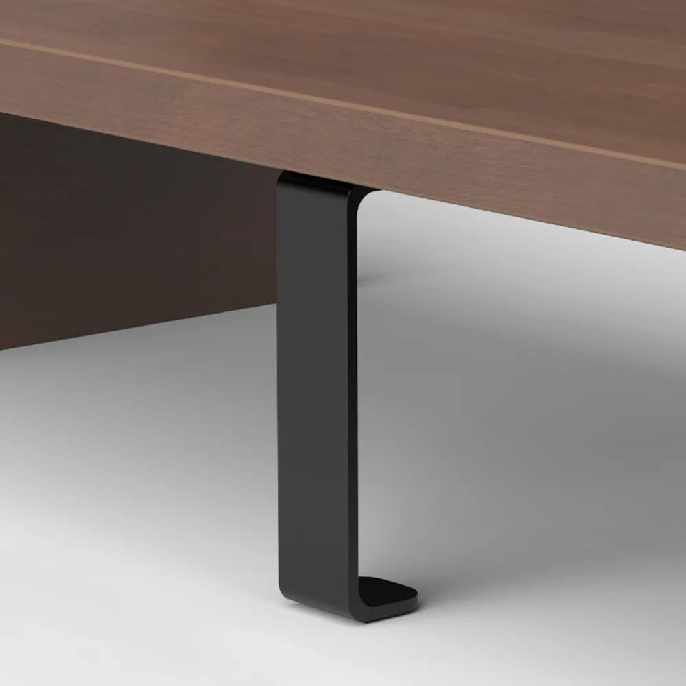 Close-up of the sturdy leg of a wooden monitor riser, part of an ergonomic desk setup in Singapore.