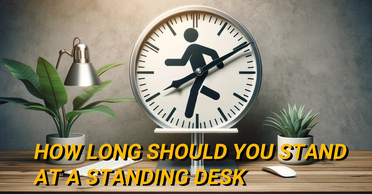 Clock with icon of a person standing, placed on a wooden desk with a standing desk in the background.