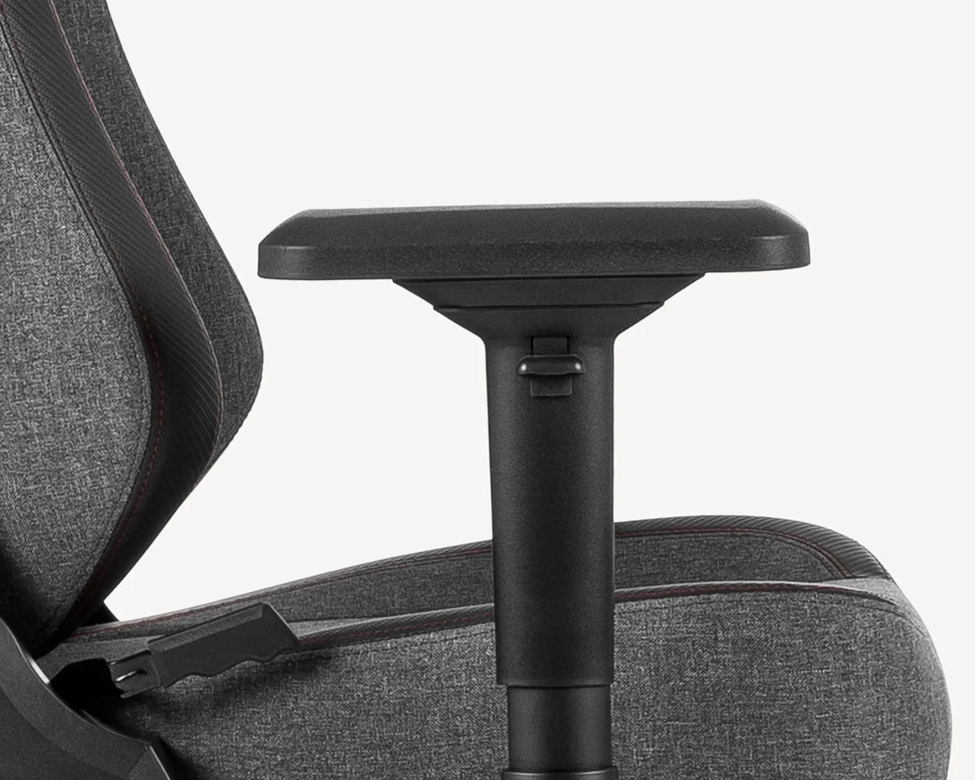 Close-up of a 4D armrest on a grey gaming chair providing multi-directional support, as part of TRITON's ergonomic chair features.