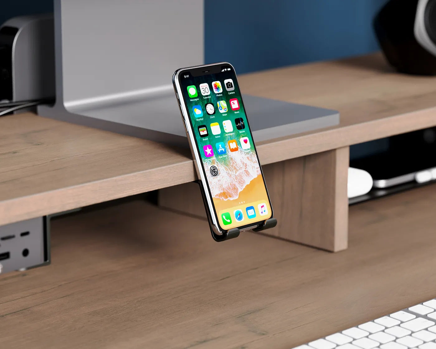 A close-up of a smartphone docked on a wooden monitor riser, highlighting the riser's functionality and smart design.