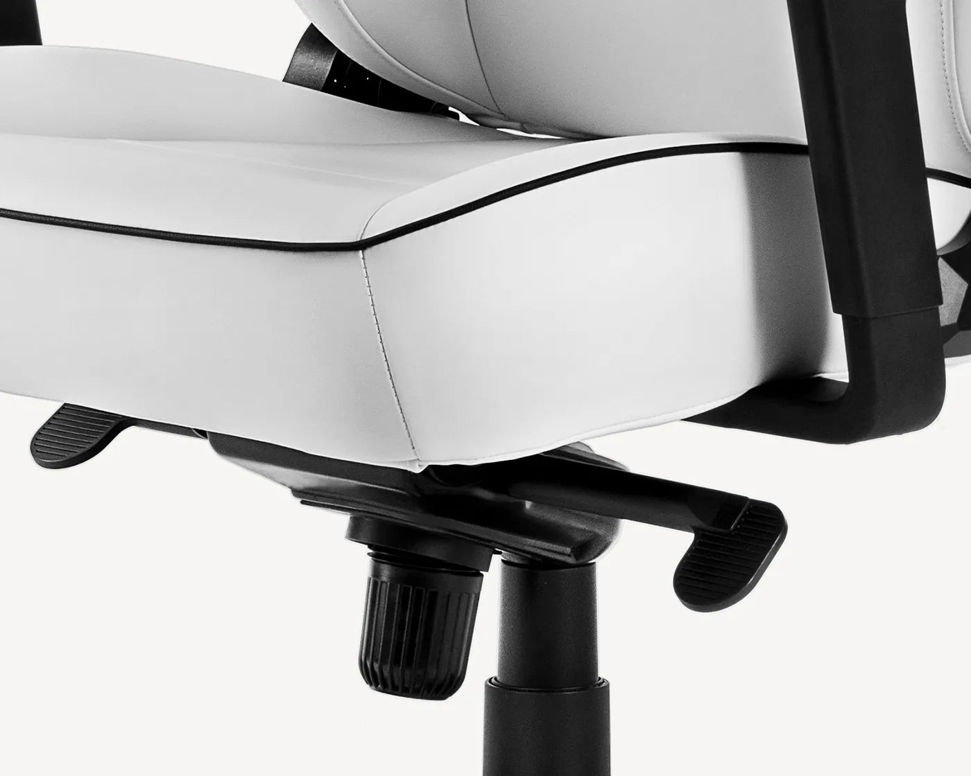 Close-up of white ergonomic chair's base showing max weight capacity and gas lift mechanism.