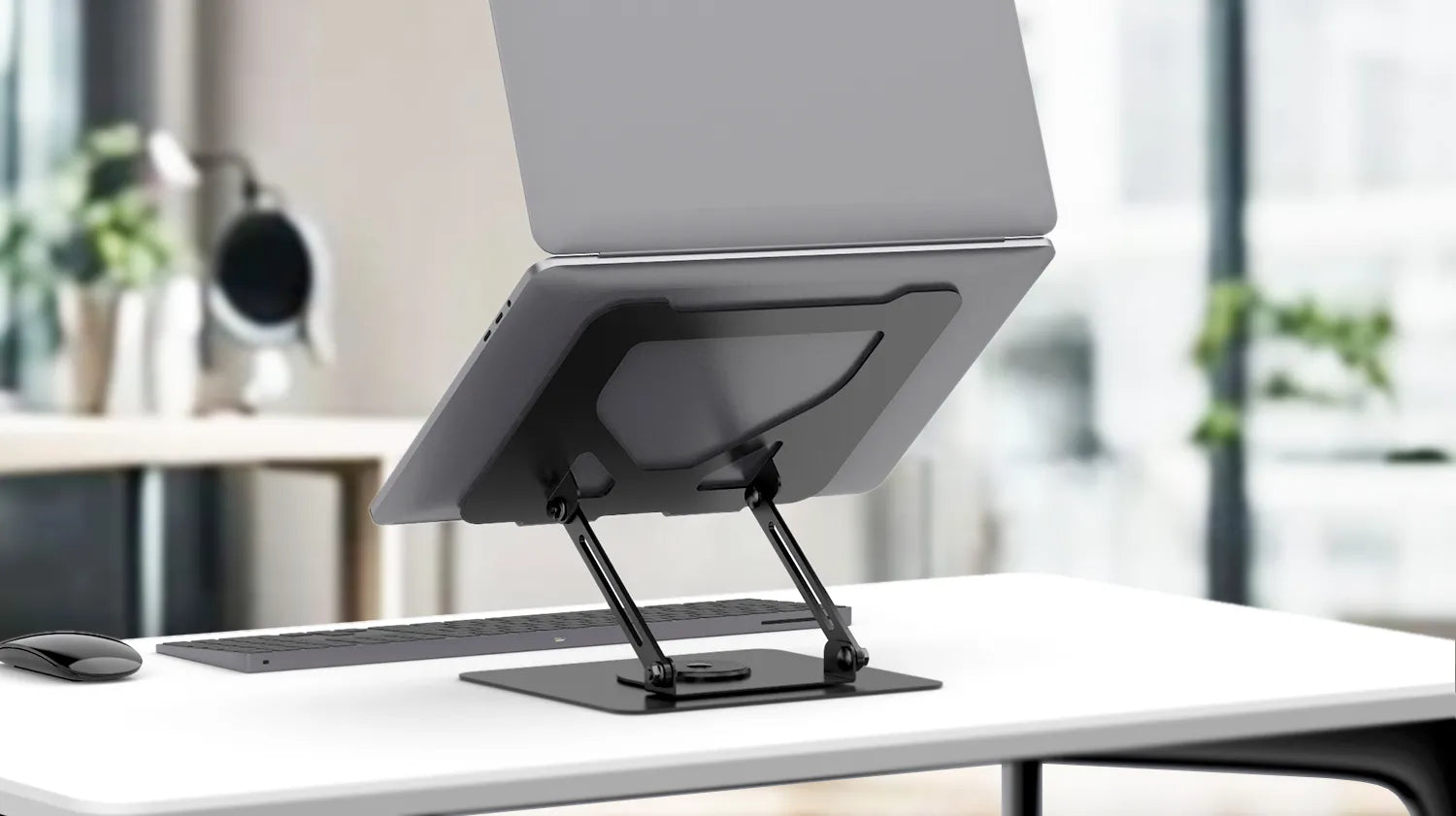 Sleek Flujo laptop stand elevating laptop for ergonomic desk setup.