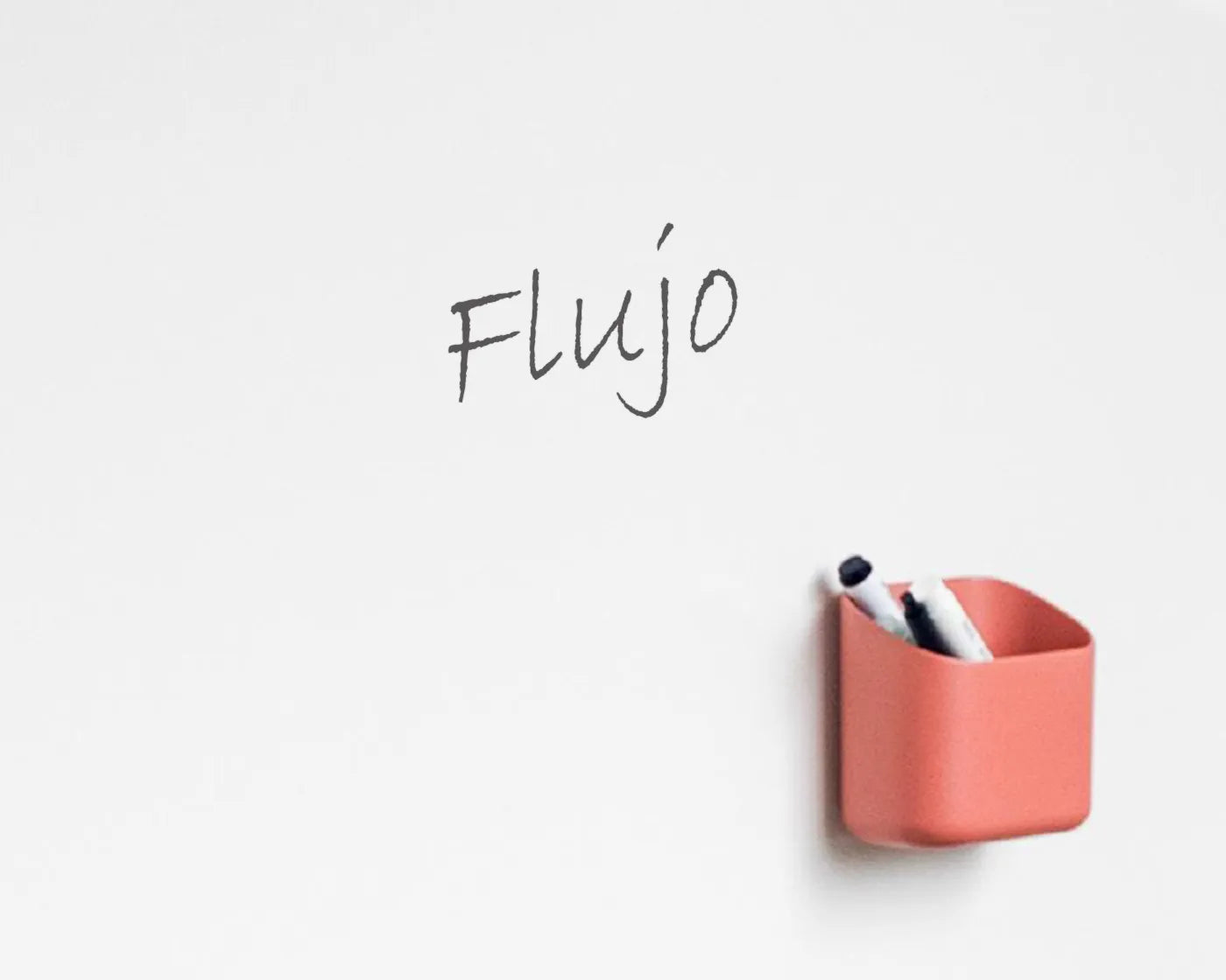 Close-up of the Flujo ThinkBoard's marker holder, a convenient feature for organizing markers and accessories in office environments.