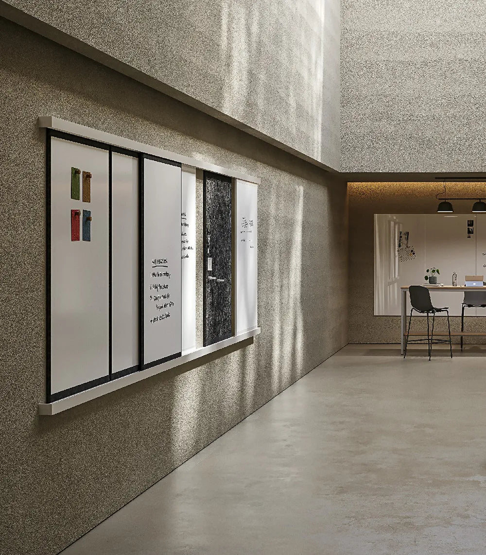 Flujo WriteDeck featured in a modern collaboration hub showcasing wall-mounted panels for brainstorming.