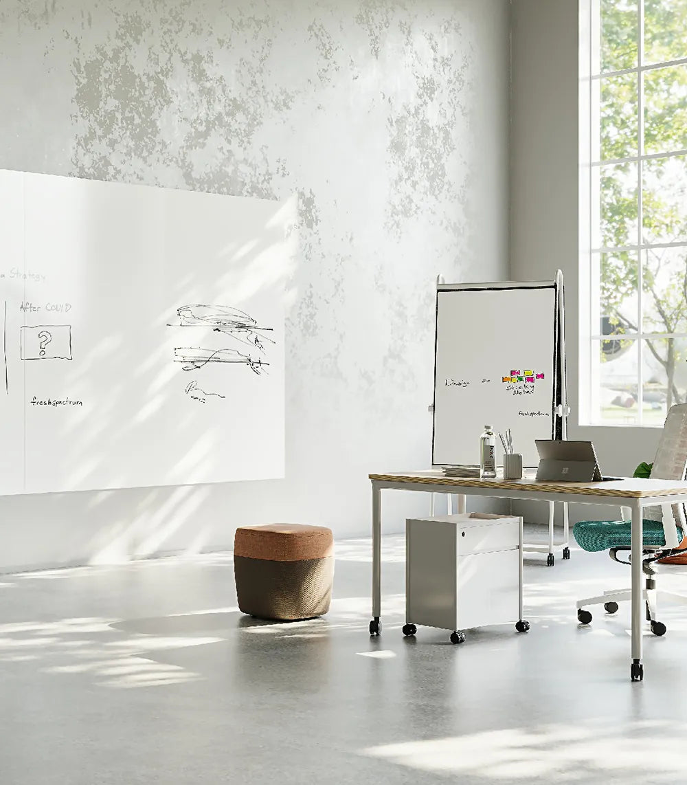 Flujo WriteDeck in a spacious collaborative area featuring wall-mounted boards for team discussions.