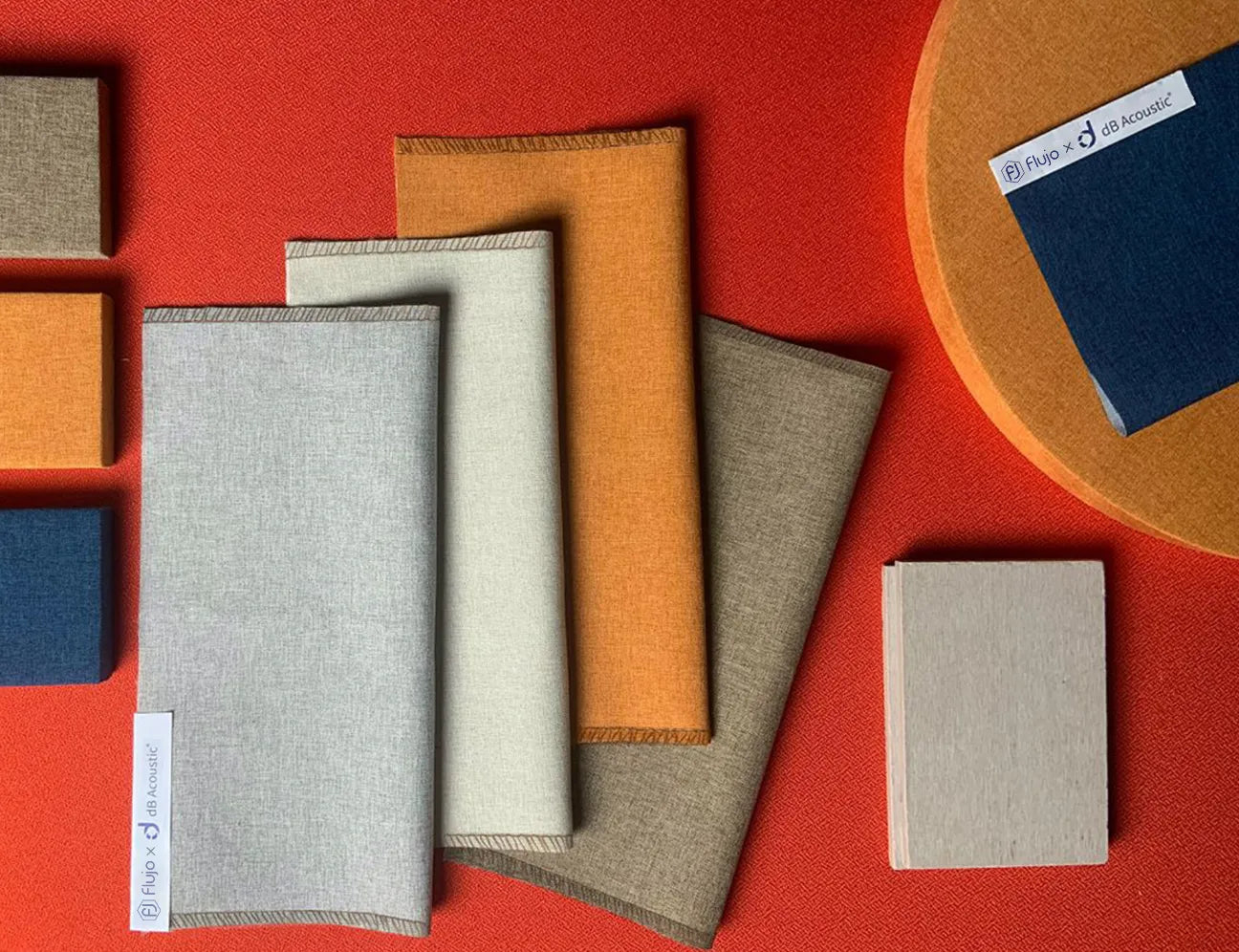 Flujo X dB Acoustic® fabric collection showcasing premium materials in vibrant colors designed for superior sound absorption and acoustic performance