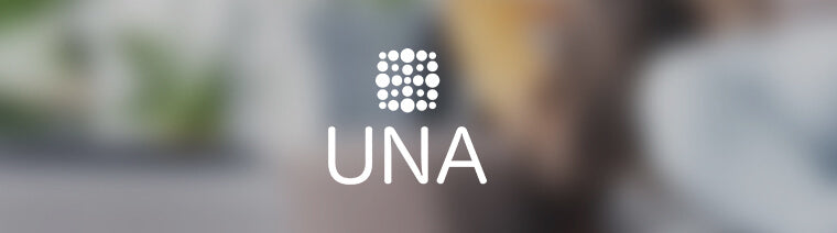 UNA brand emblem with a soft focus background, symbolizing clarity and focus in product design from Singapore.