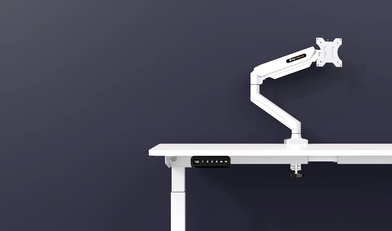 Flujo white monitor arm attached to a minimalist desk with digital height display